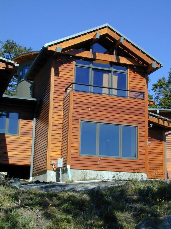 WESTERN RED CEDAR BEVEL SIDING, WITH A COAT OF CLEAR STAIN APPLIED TO IT.
