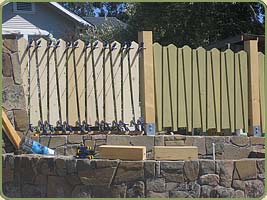the cedar boards being installed on the fence