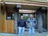 Cloud and Richard pose in front of the finished project. Shown: wrc fascia and soffit.
