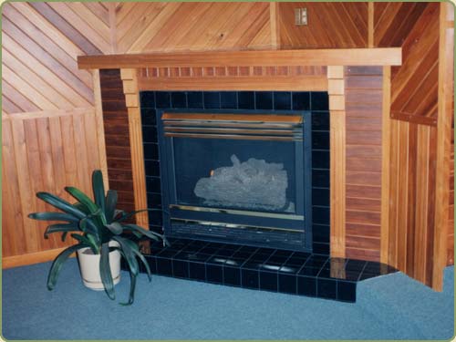 a fireplace and wall with red cedar paneling