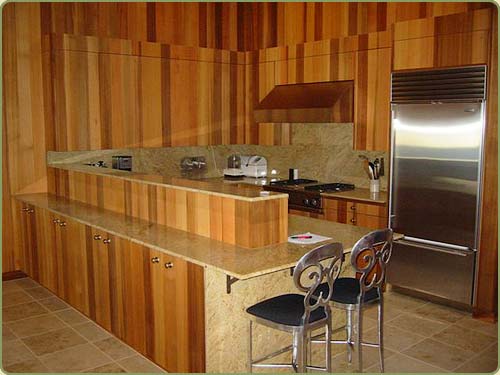 image of a kitchen with western red cedar paneling and cabinets matched for grain.