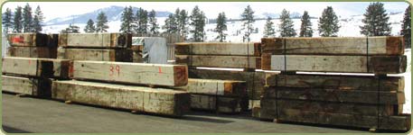 a load of recycled wood awaits to be milled