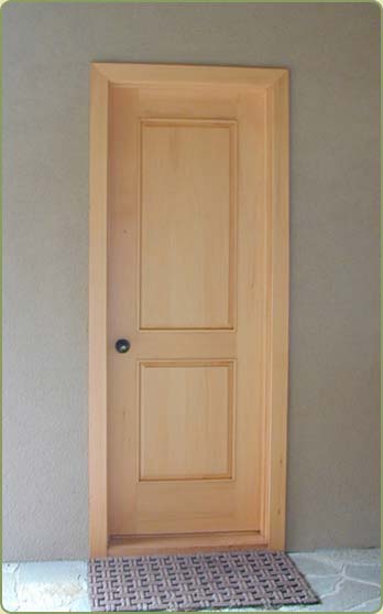 Image of alaskan yellow cedar trim around door and boards the door