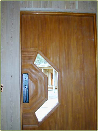 Image of a door with western red cedar trim, also shown is fir interior paneling