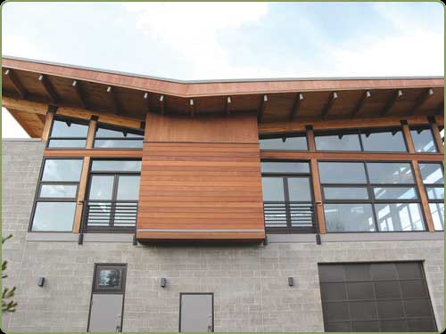 redwood siding, glass and concrete walls.